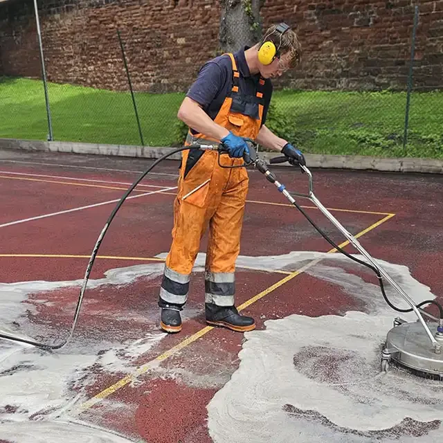 man cleaning sports courrt
