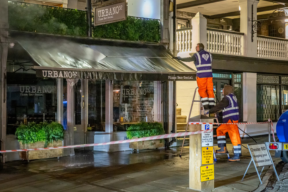 jetwashing awning of restaurant