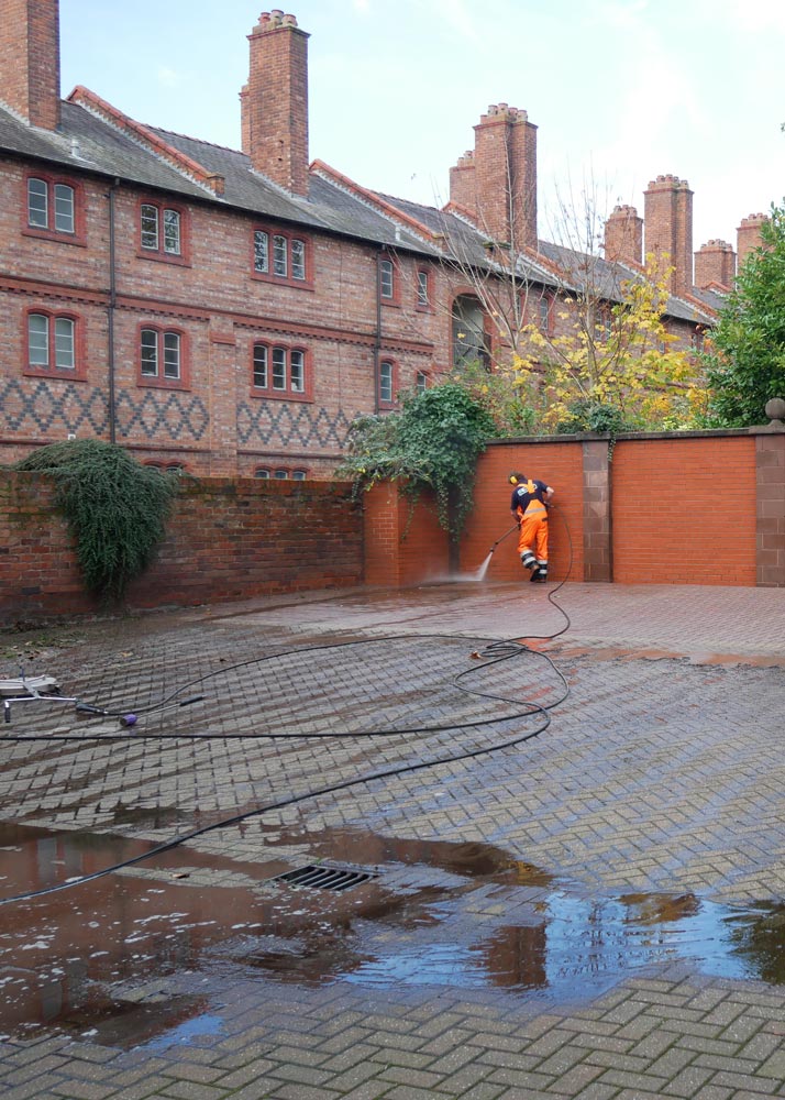 man cleaning car park